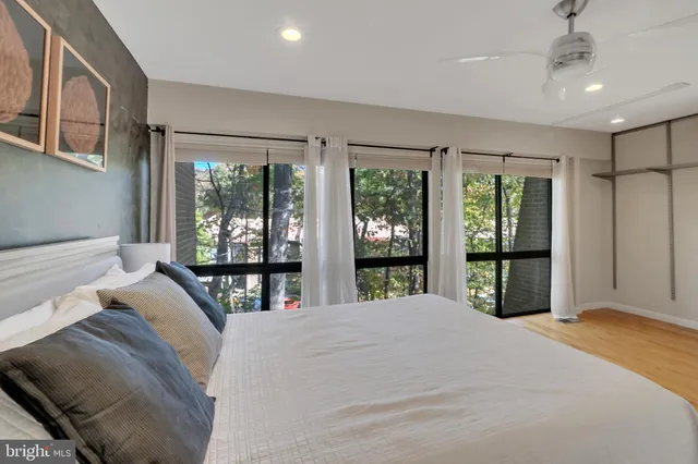 a bedroom with a large bed and a large window