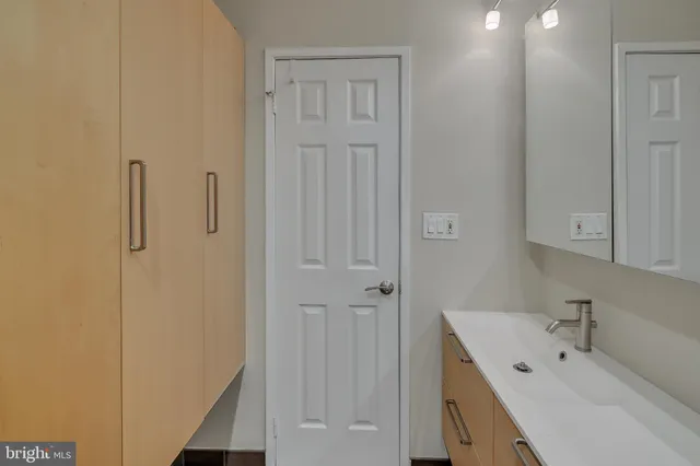 a bathroom with a tub sink vanity and view