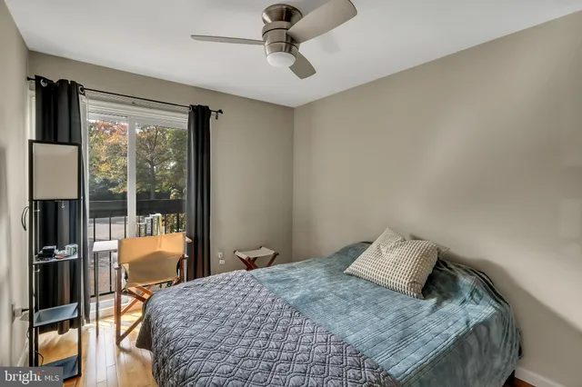 a bedroom with a bed and glass walk in closet