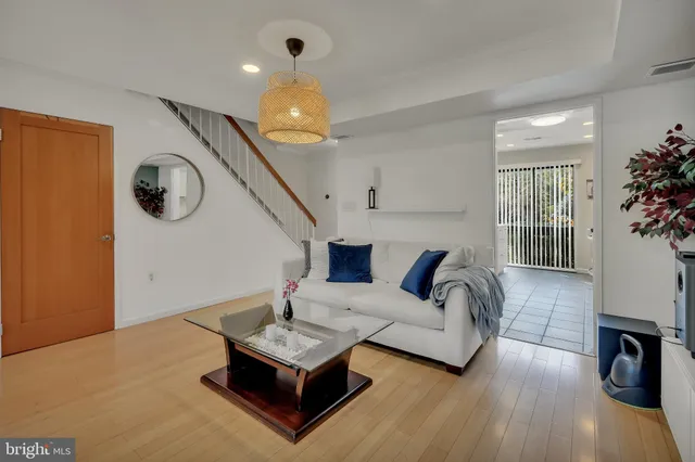 a living room with furniture and a wooden floor