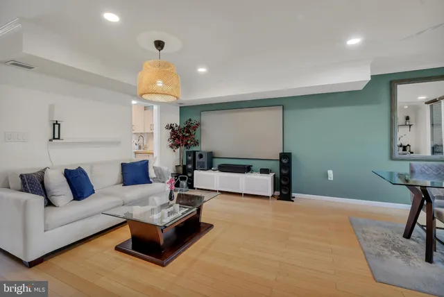 a living room with furniture and a chandelier