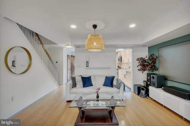 a living room with furniture and a chandelier