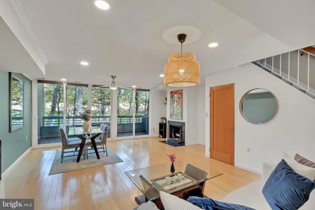 a living room with furniture fireplace and a large window