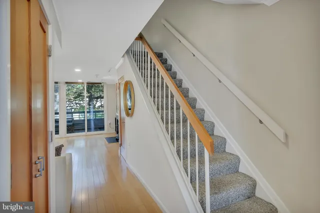 a view of entryway and hall with wooden floor