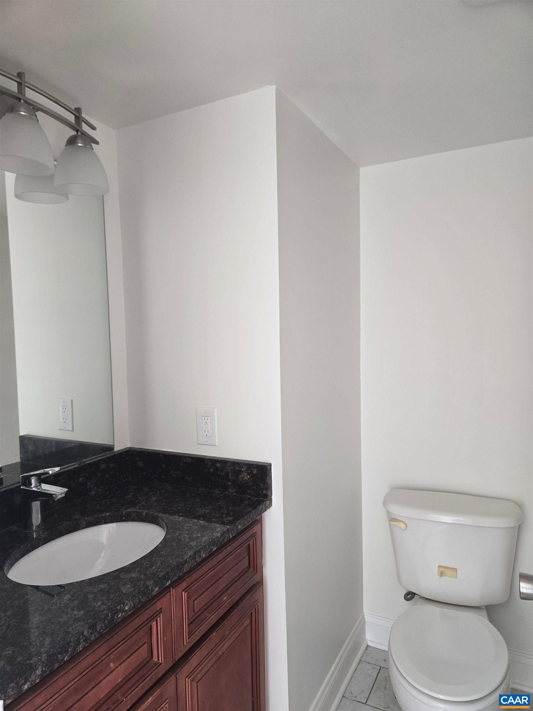 1750 Rosser Avenue, Unit 141A BRANDON LADD CIR Waynesboro, VA 22980 - Photo 3 of 6 a bathroom with a granite countertop sink and a mirror