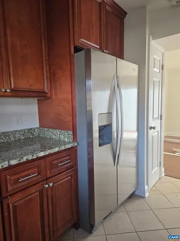 a kitchen with stainless steel appliances granite countertop a refrigerator and a stove