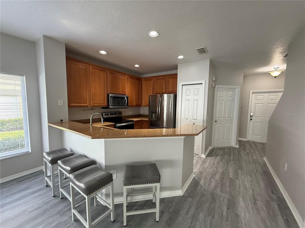 20460 Needletree Drive Tampa, FL 33647 - Photo 14 of 28 a kitchen with granite countertop counter space a sink appliances and cabinets