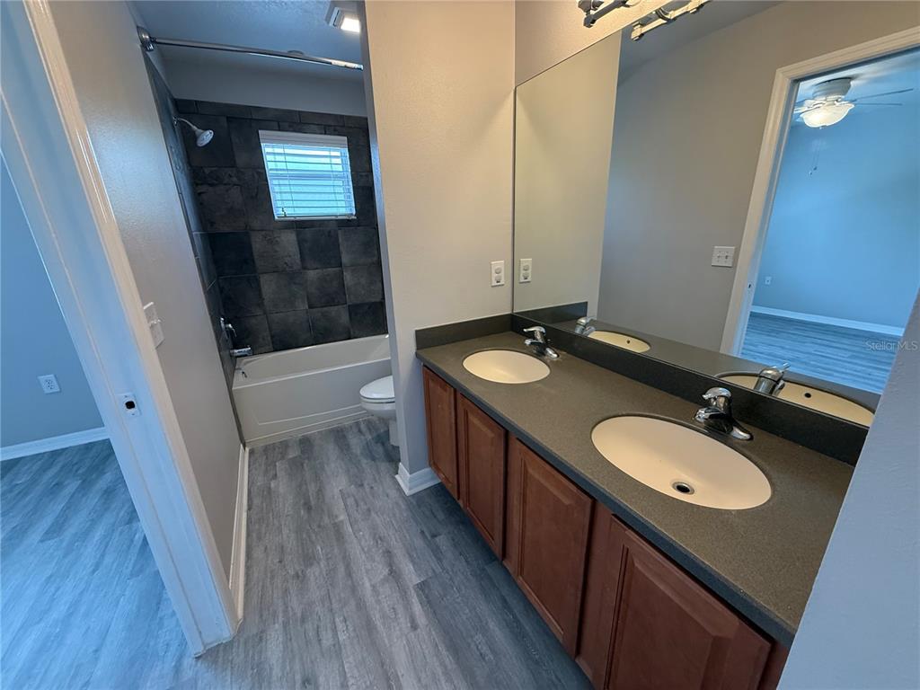 20460 Needletree Drive Tampa, FL 33647 - Photo 18 of 28 a bathroom with a double vanity sink and a mirror