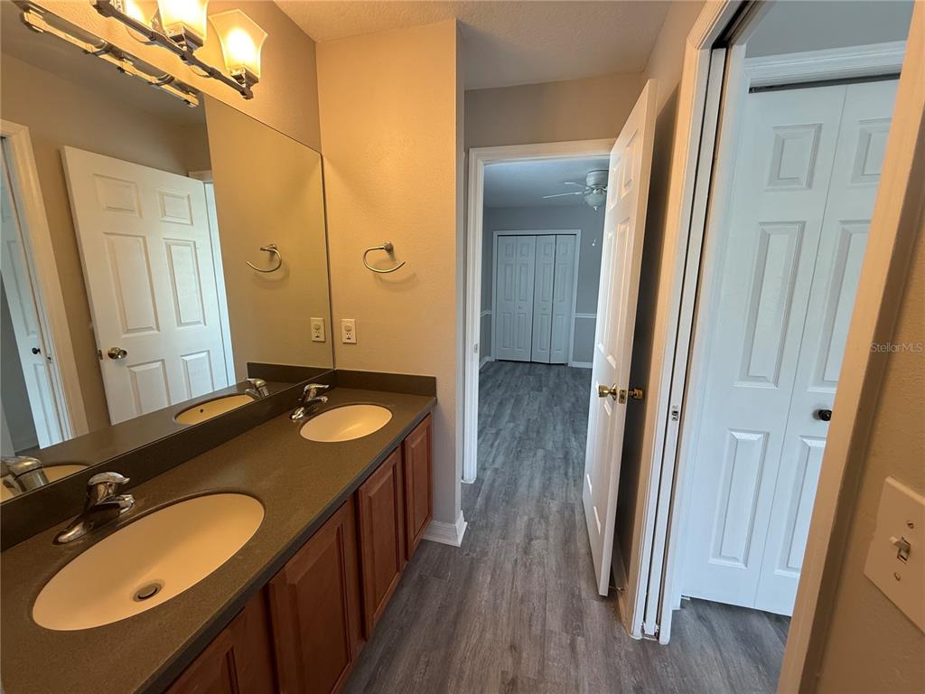 20460 Needletree Drive Tampa, FL 33647 - Photo 20 of 28 a bathroom with a double vanity sink and a mirror