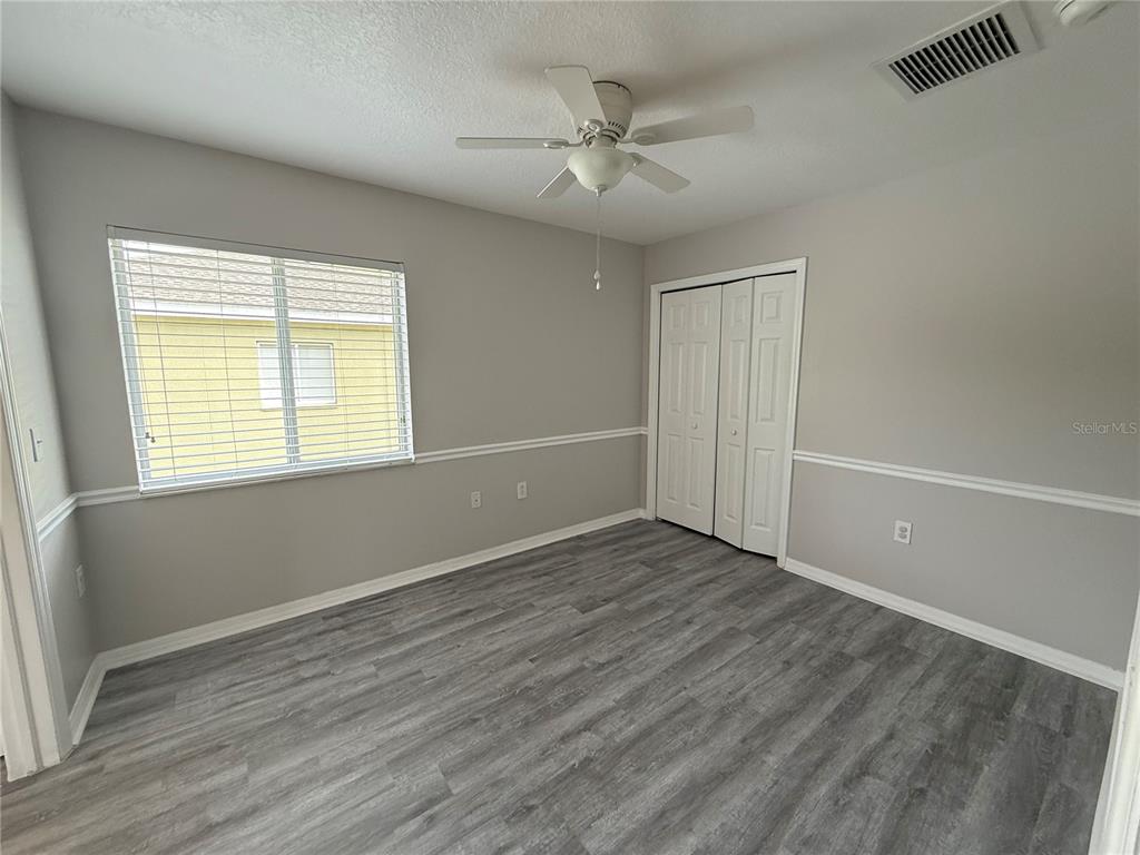 20460 Needletree Drive Tampa, FL 33647 - Photo 22 of 28 a view of an empty room with wooden floor and a window