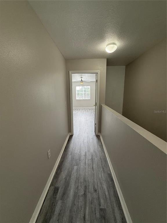 20460 Needletree Drive Tampa, FL 33647 - Photo 23 of 28 a view of a hallway with wooden floor