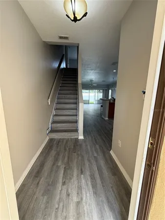 a view of entryway and hall with wooden floor