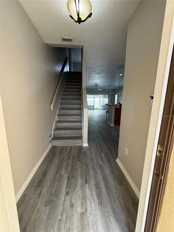 a view of entryway and hall with wooden floor