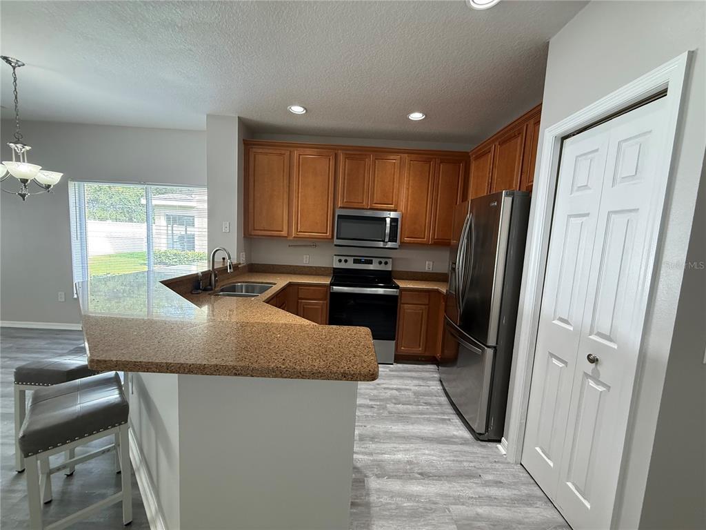 20460 Needletree Drive Tampa, FL 33647 - Photo 7 of 28 a kitchen with kitchen island a counter top space appliances and a window