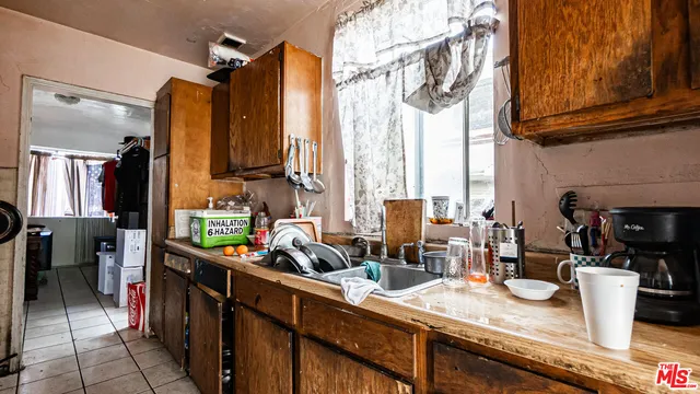 a kitchen with stainless steel appliances kitchen island granite countertop a sink and cabinets