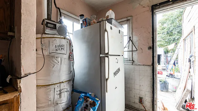 a living room with furniture a bed and a large window