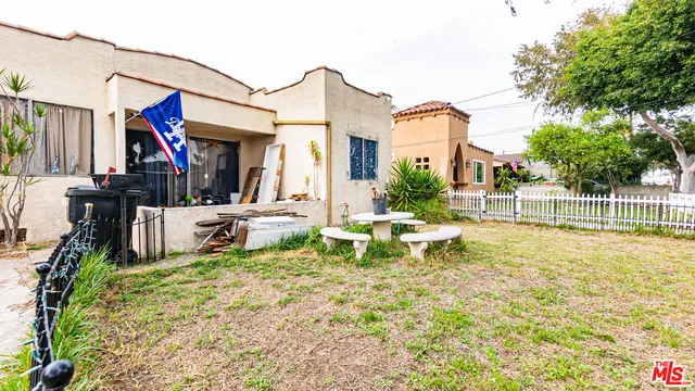 a view of a house with swimming pool and sitting area