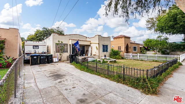 a view of a house with swimming pool and sitting area