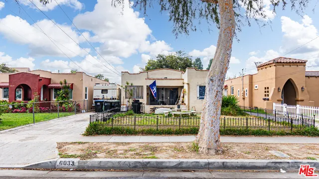 a view of a house with a garden and pathway