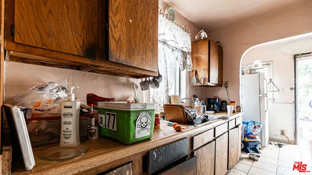 a kitchen with stainless steel appliances wooden cabinets a stove and a refrigerator