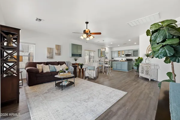 a spacious bedroom with a bed and a chandelier