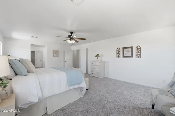a spacious bedroom with a bed and a window