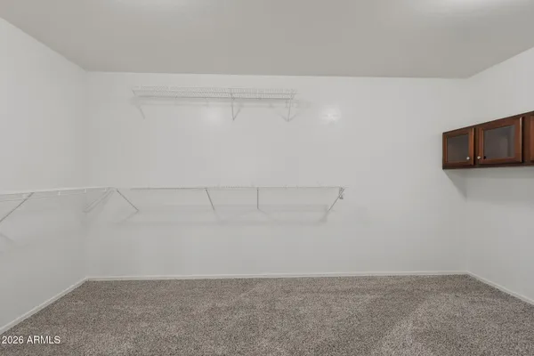 an empty room with a window and a ceiling fan