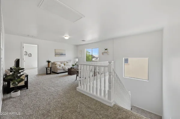 an empty room with a window and a ceiling fan