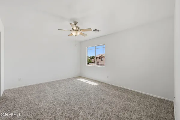 a bathroom with a double vanity sink a toilet a mirror and bathtub