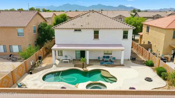 a swimming pool with outdoor seating and yard