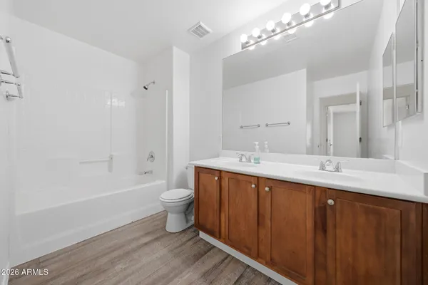 an aerial view of residential houses with outdoor space and ocean view