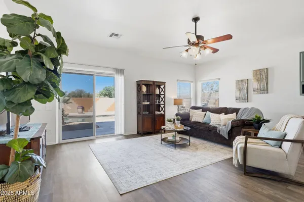 a kitchen with stainless steel appliances granite countertop a stove top oven a sink dishwasher a dining table and chairs with wooden floor