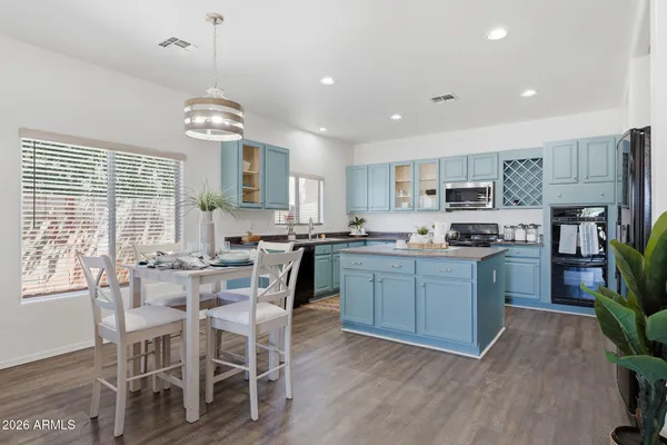 a spacious bathroom with a double vanity sink a mirror and a shower