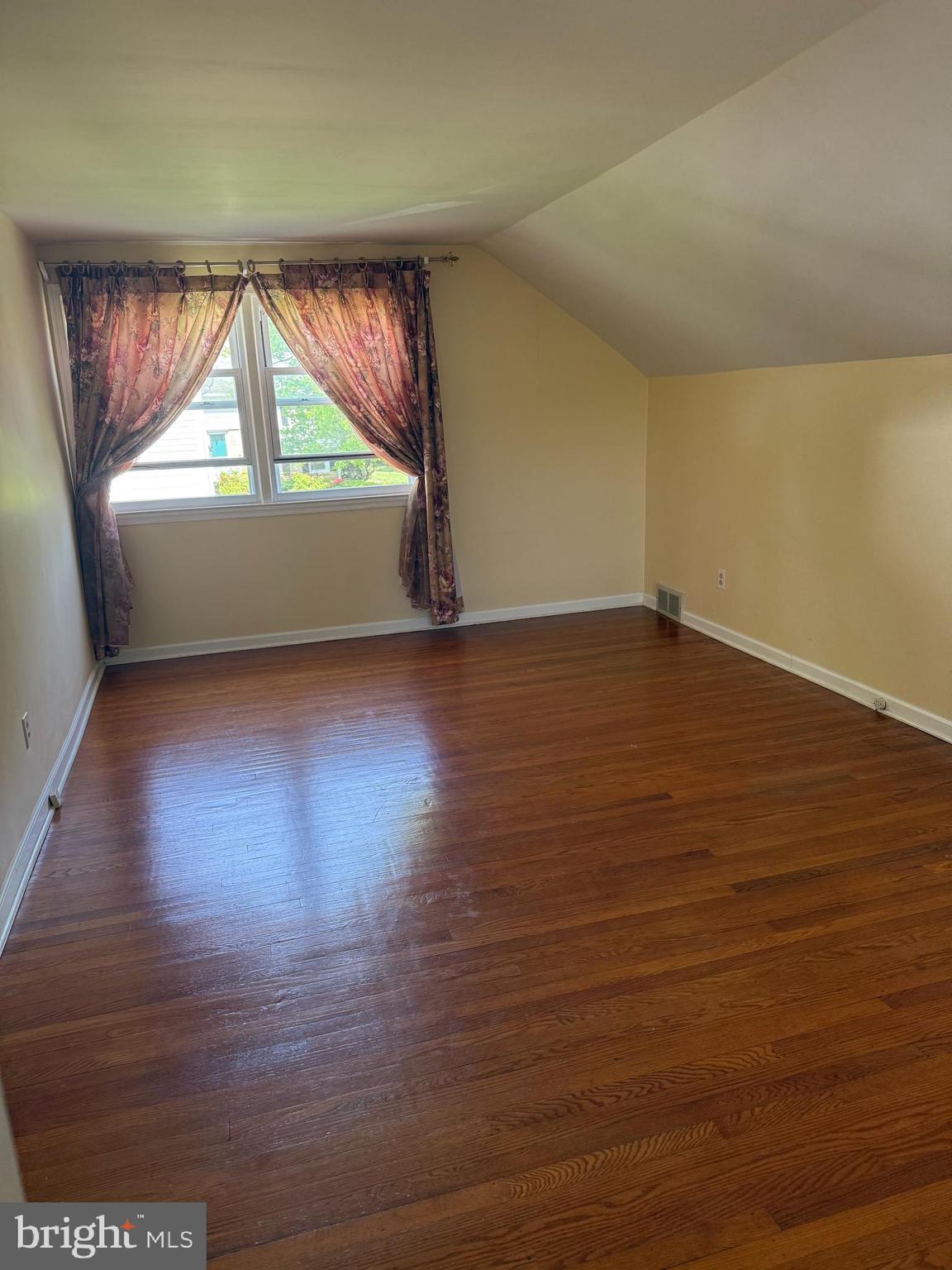 109 Valley Forge Terrace Wayne, PA 19087 - Photo 11 of 13 an empty room with wooden floor and windows