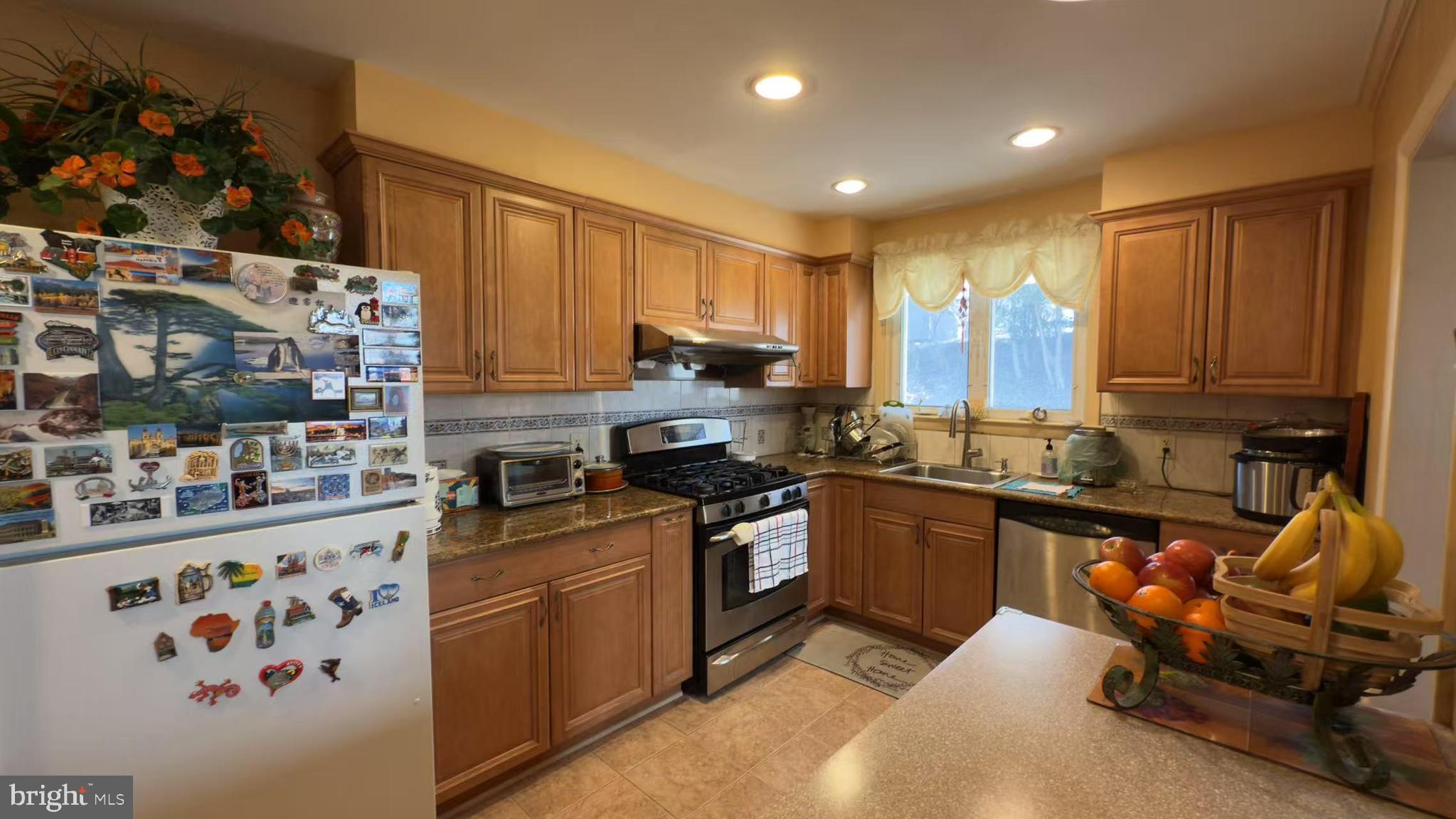 109 Valley Forge Terrace Wayne, PA 19087 - Photo 5 of 13 a kitchen with stainless steel appliances granite countertop a sink stove and refrigerator