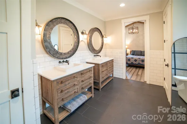 a bathroom with a double vanity sink and a mirror