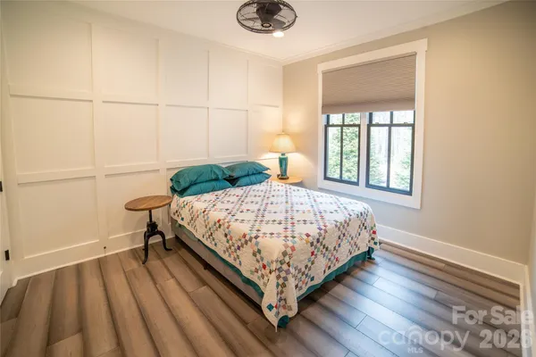a bed sitting in a bedroom next to a window