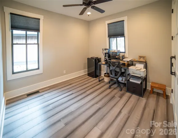 a workspace with wooden floor and a window