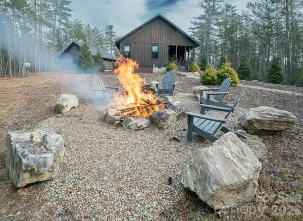 a backyard of a house with table and chairs