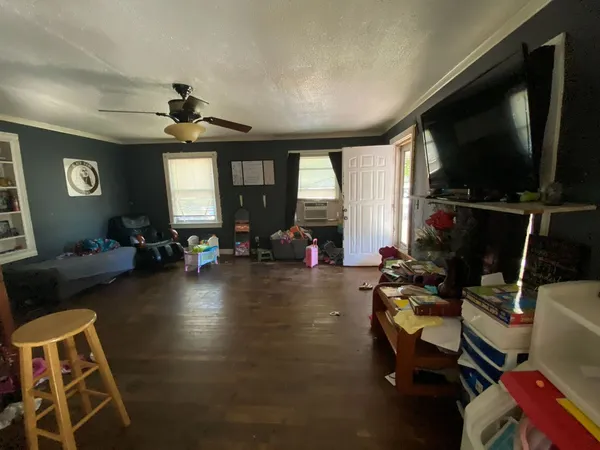 a living room with furniture and a flat screen tv