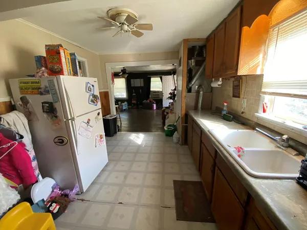 a kitchen with refrigerator a stove a sink and a refrigerator
