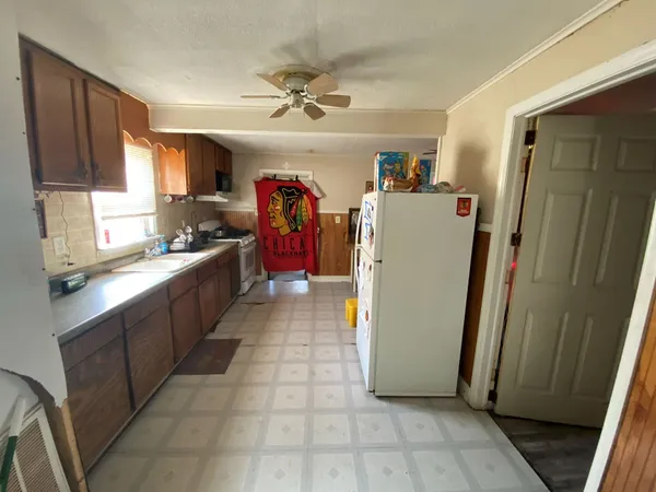 a room with a refrigerator and a sink