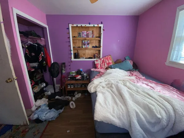 a bedroom with a bed and a mirror