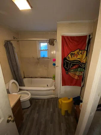 a bathroom with a toilet and a shower