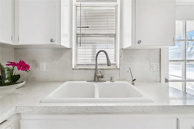 a bathroom with a sink and a window