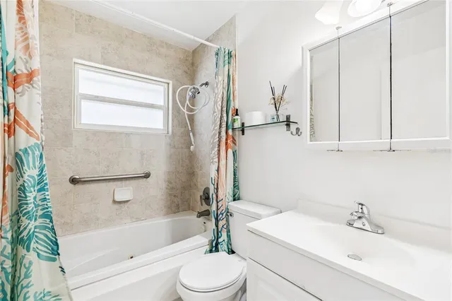 a bathroom with a bathtub toilet sink vanity and mirror