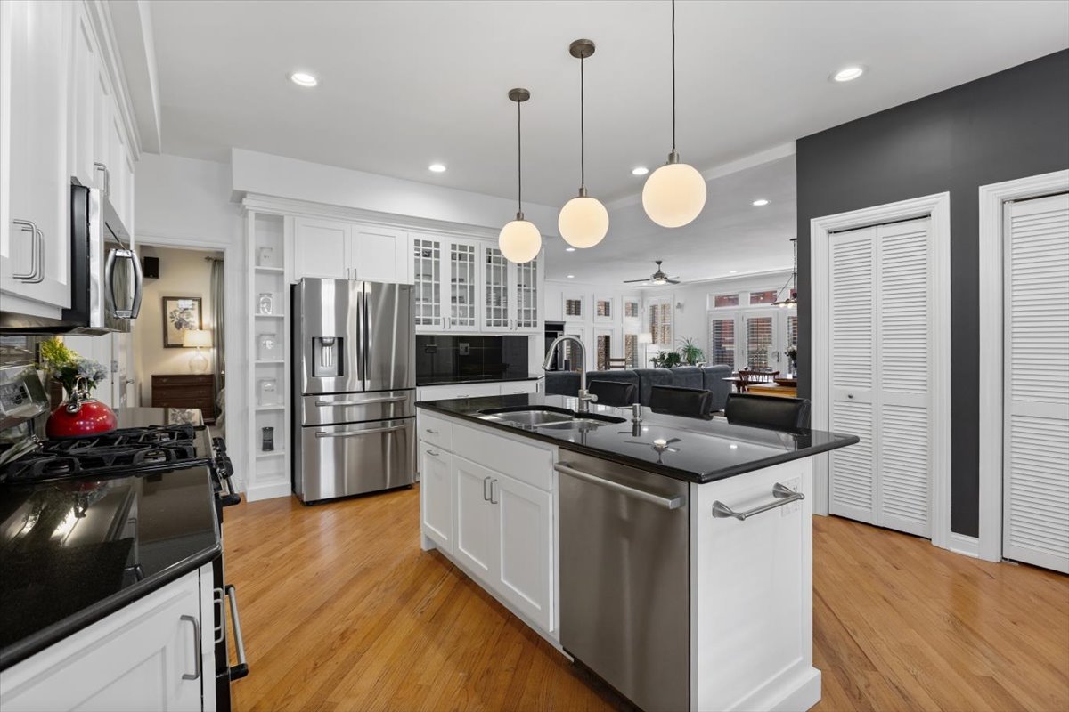 1249 North Wolcott Avenue, Unit 2 Chicago, IL 60622 - Photo 12 of 26 a kitchen with stainless steel appliances granite countertop a sink a stove and refrigerator