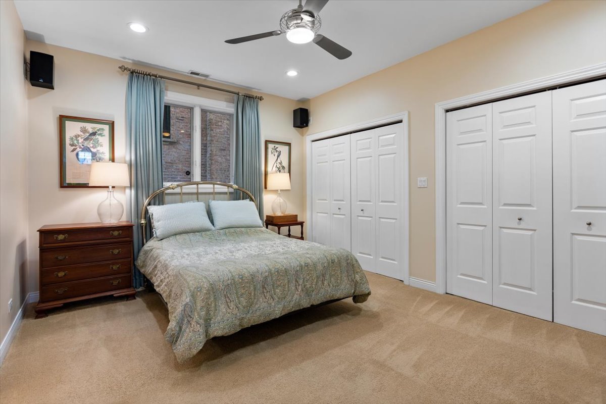 1249 North Wolcott Avenue, Unit 2 Chicago, IL 60622 - Photo 14 of 26 a spacious bedroom with a bed and a ceiling fan