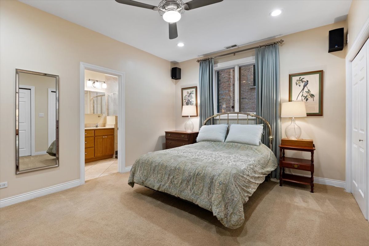 1249 North Wolcott Avenue, Unit 2 Chicago, IL 60622 - Photo 15 of 26 a spacious bedroom with a bed and a chandelier
