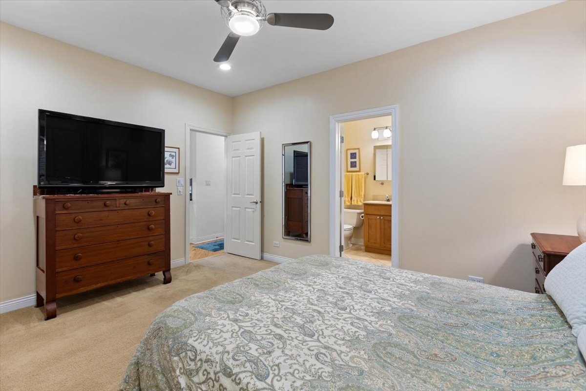 1249 North Wolcott Avenue, Unit 2 Chicago, IL 60622 - Photo 16 of 26 a bedroom with furniture and flat screen tv